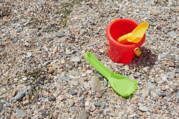 Bucket, rake and beach shovel on the beach sand, Vera, Spain
