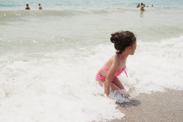 Girl playing happily on the shore of the beach, Vera, Spain