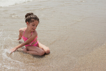 Girl playing happily on the shore of the beach, Vera, Spain