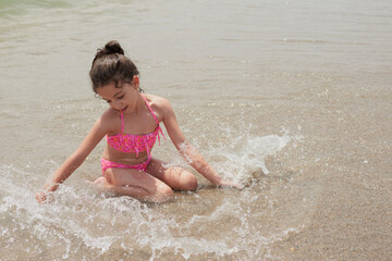 Girl playing happily on the shore of the beach, Vera, Spain