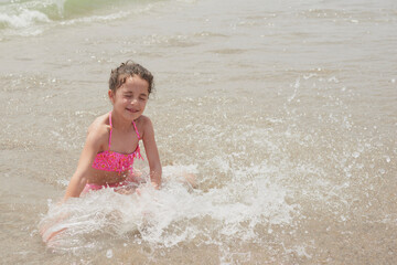 Girl playing happily on the shore of the beach, Vera, Spain
