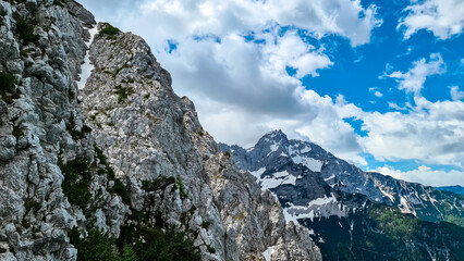 Fototapeta na wymiar Scenic view on rocky sharp summit of Jezerska Kocna in Kamnik Savinja Alps in Carinthia, border Austria and Slovenia. Mountain peaks in the Vellacher Kotschna. Mountaineering. Freedom concept