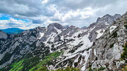 Fototapeta na wymiar Scenic view on rocky sharp summit of Jezerska Kocna in Kamnik Savinja Alps in Carinthia, border Austria and Slovenia. Mountain peaks in the Vellacher Kotschna. Mountaineering. Freedom concept