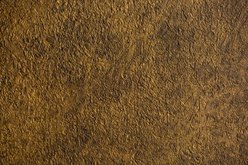 Brown background from decorative plaster with abstract spots. Unusual beige wall texture with beautiful patterns, creative surface background. Front covering for facing of buildings.