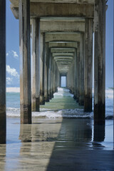 view of waves crashing under the pier