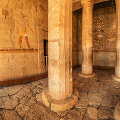 Hieroglyphs and paintings carved in sandstone columns in Hatshepsut temple in Luxor. Egyptian...