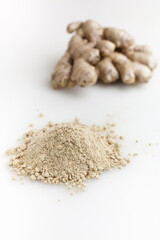 Heap of dried ginger powder and fresh ginger. Isolated on white background.