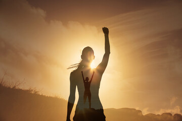 Strong young woman with fist up on a mountain. Never give up, and people power concept. Double...