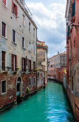 Morning in Venice, water channels along residential buildings, cityscape