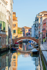 Morning in Venice, water channels along residential buildings, cityscape