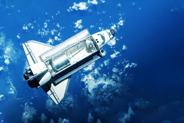 Space shuttle over the planet. Elements of this image furnished by NASA