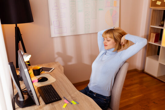 Tired woman stretching out while working in an office