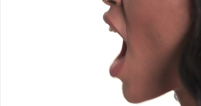 Close up side view of a black woman mouth shouting.