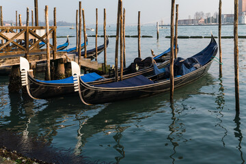 Fototapeta na wymiar gondolas parked by the grand canal in Venice, Italy with the church of Saint Giorgio Maggiore in the background