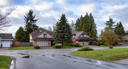 Fototapeta na wymiar Fraser Heights, Surrey, Greater Vancouver, BC, Canada. Street view in the Residential Neighborhood during a colorful spring season. Colorful Sunrise Sky.