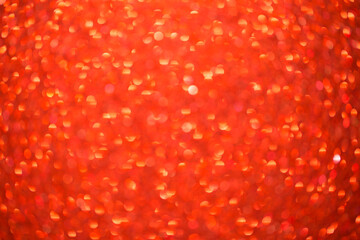 Red bokeh background. Festive Christmas shiny background. Glittering red light.