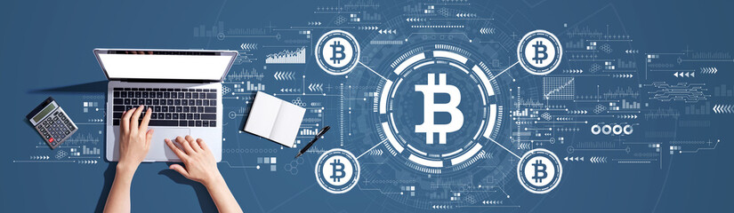Bitcoin theme with person using a laptop computer