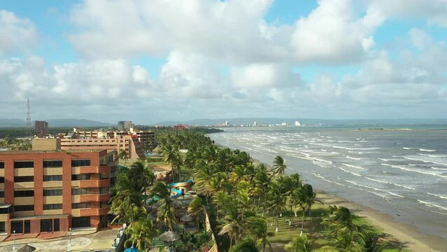 Paradisiacal place of palm trees and sea in Tucacas, Venezuela, aerial View.