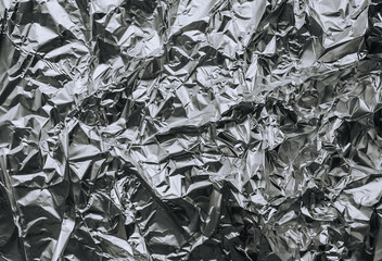 Background, texture of silver foil, colored paper. Photo, top view, copy space.