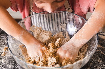 Little girl kneading in the kitchen. 