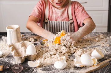 Little girl kneading in the kitchen. 