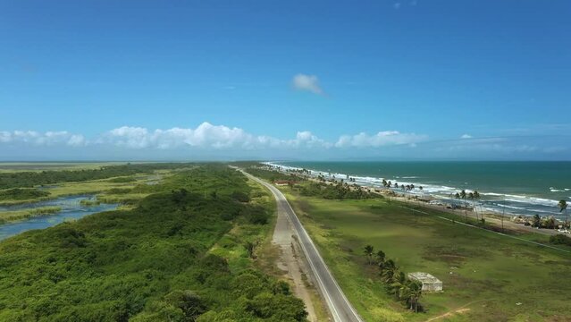 Beautiful Caribbean road with palm trees along the coast of Venezuela, road happy tucacas, Aerial view
