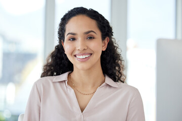 It takes dedication, and I have loads. Portrait of a young businesswoman working on a computer in...