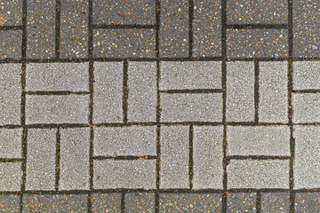Texture of paving slabs lined with graphic ornament. White and gray stones without additional coloring