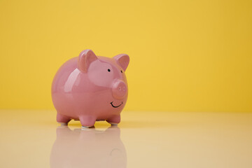 Piggy bank on yellow background. Investmenst and savings concept