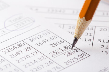 Accounting document with pencil and checking financial chart. Concept of banking, financial report and financial audit.