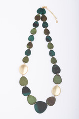 Green turquoise necklace isolated on white background with a soft texture