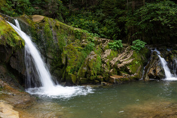 Fototapeta premium Two small mountain waterfalls in forest