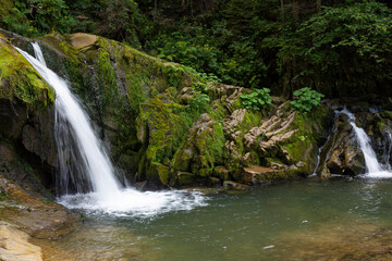 Two small mountain waterfalls in forest