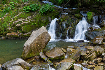 Naklejka na ściany i meble Two small mountain waterfalls in forest