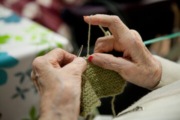 Retired knitting in a retirement home.