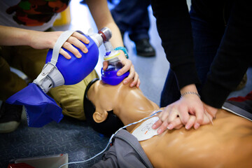 First aid training: alternate use of a manual resuscitator bag. - obrazy, fototapety, plakaty