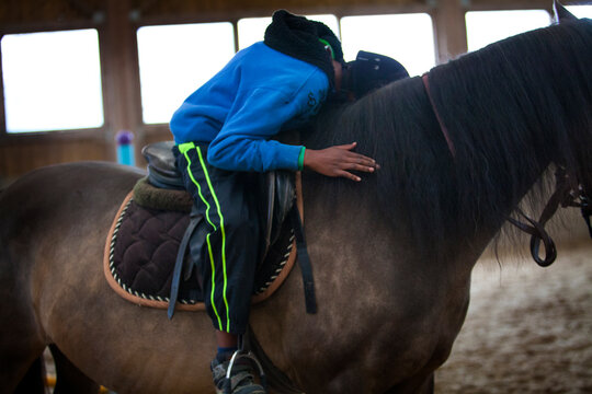 Equitherapy session for an autistic in an equestrian center.