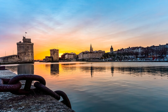 Panoramic view of the famous old harbor of La Rochelle at sunset. metal chain in the foreground