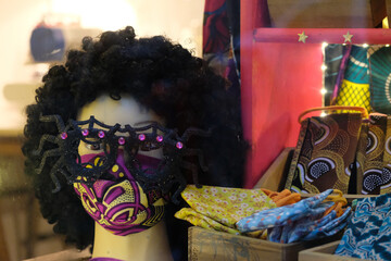 Masked mannequin in a tailor shop.