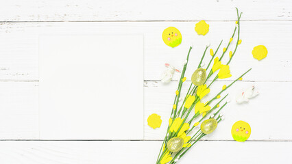 Colorful background with Easter eggs on white wooden board background.