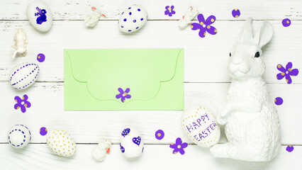 Colorful background with Easter eggs on white wooden board background.