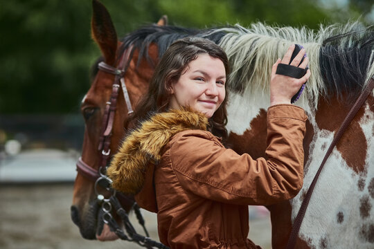 Whoever said you cant buy happiness never had a pony. Shot of a teenage girl brushing her ponys hair on a farm.