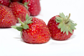 Strawberries on a white background. Strawberry close-up isolated. Juicy berries picked for dessert.