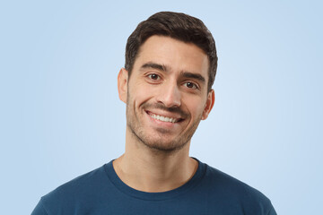 Cheerful smiling attractive young man in blue t-shirt
