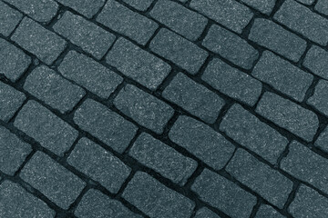 Diagonal layout of cobbled pavement. oblong pavement stone