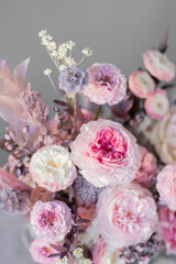 Flowers arrangement with roses in bark pot in vintage.