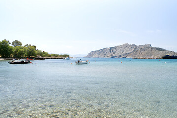 Fototapeta premium Yachts in the sea on the background of the Greek island. close up