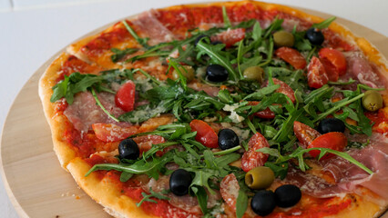 Italian pizza on a wooden plate