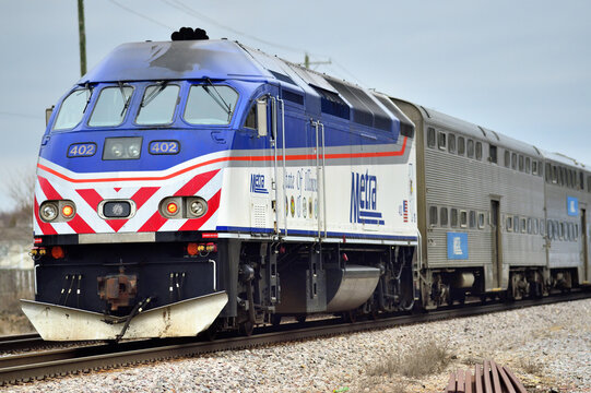 A Metra commuter train passing through the northwest suburbs on its journey to Chicago. The locomotive is decked out in a special paint scheme paying tribute to the State of Illinois.