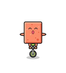 The cute brick character is riding a circus bike